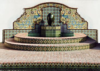 Peacock Mural shown as wall fountain with Diva Deco base
